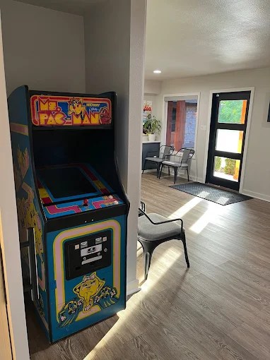 A nostalgic Ms. Pac-Man arcade cabinet tucked into a corner of the office for patient entertainment.