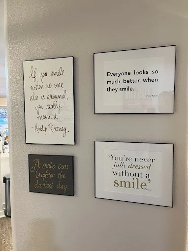 Three framed minimalist art pieces or quotes hanging on a neutral-colored wall.