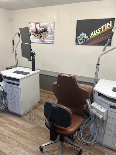 A second clinical view showing a dental chair and professional cabinetry in a bright, clean environment.