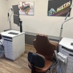 A second clinical view showing a dental chair and professional cabinetry in a bright, clean environment.